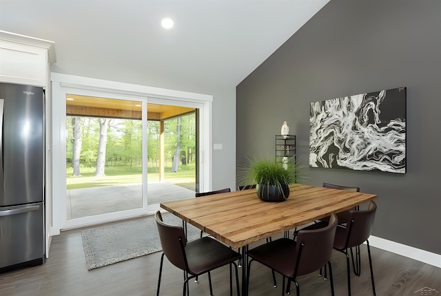 2291 E Maple Rd, Clare, MI 48617 - dining space with lofted ceiling, dark wood-style flooring, and baseboards