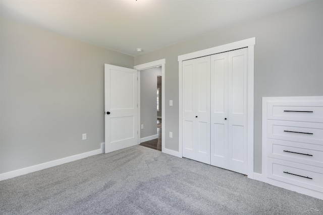 2291 E Maple Rd, Clare, MI 48617 - unfurnished bedroom featuring carpet flooring, a closet, and baseboards