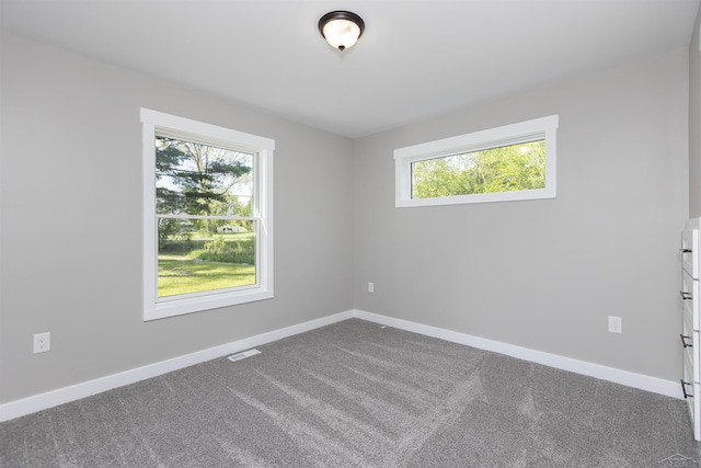 2291 E Maple Rd, Clare, MI 48617 - spare room with dark colored carpet and baseboards