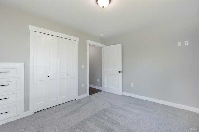 2291 E Maple Rd, Clare, MI 48617 - unfurnished bedroom featuring carpet, a closet, and baseboards