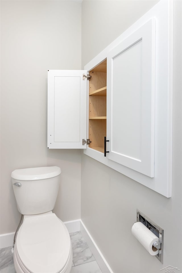 2291 E Maple Rd, Clare, MI 48617 - bathroom featuring baseboards and marble look tile flooring