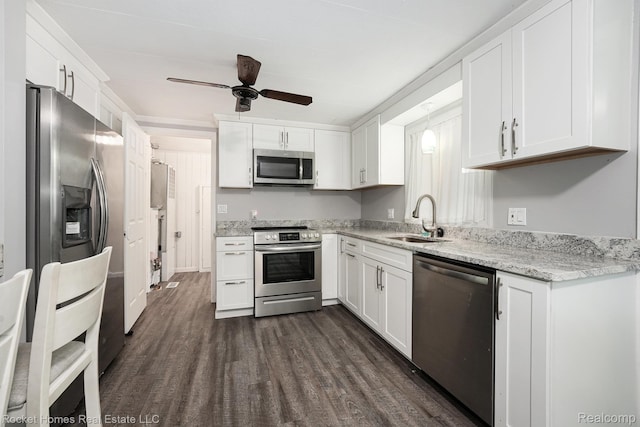 9689 Pine Ln, Evart, MI 49631 - kitchen featuring stainless steel appliances, dark wood finished floors, a ceiling fan, and white cabinetry
