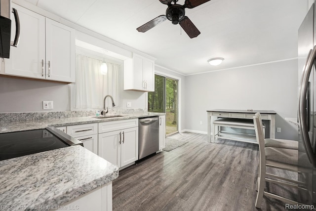 9689 Pine Ln, Evart, MI 49631 - kitchen with stainless steel appliances, dark wood-style flooring, a ceiling fan, white cabinetry, and light stone counters