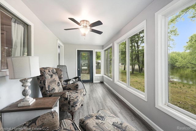 9689 Pine Ln, Evart, MI 49631 - sunroom / solarium with healthy amount of natural light, wood finished floors, and a water view