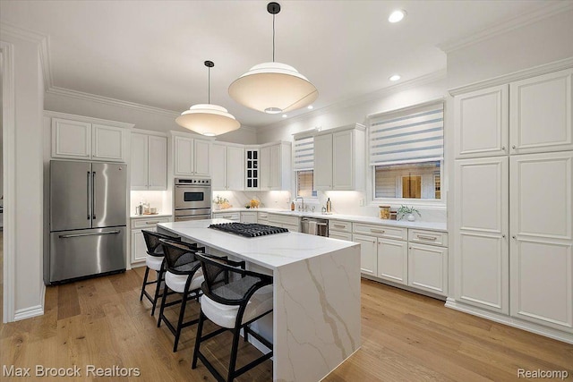 855 Wallace St, Birmingham, MI 48009 - kitchen featuring appliances with stainless steel finishes, white cabinets, crown molding, a sink, and a kitchen island