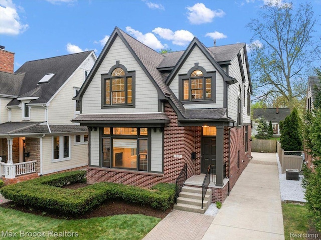 855 Wallace St, Birmingham, MI 48009 - view of front of home with brick siding, a shingled roof, and central AC unit