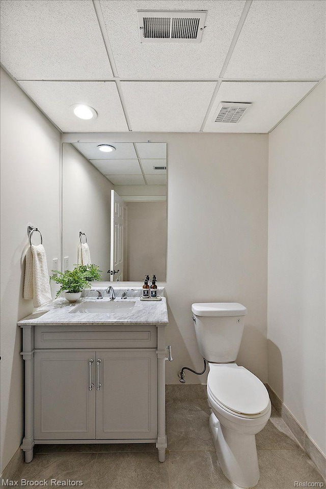 855 Wallace St, Birmingham, MI 48009 - bathroom featuring vanity, a drop ceiling, toilet, and baseboards