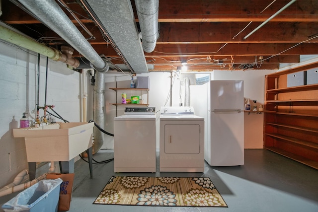 801 Briarcliff Rd, Jackson, MI 49203 - unfinished below grade area with freestanding refrigerator, washing machine and dryer, and a sink