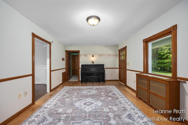 13814 28th St, Lowell, MI 49331 - unfurnished room with wood finished floors and radiator heating unit