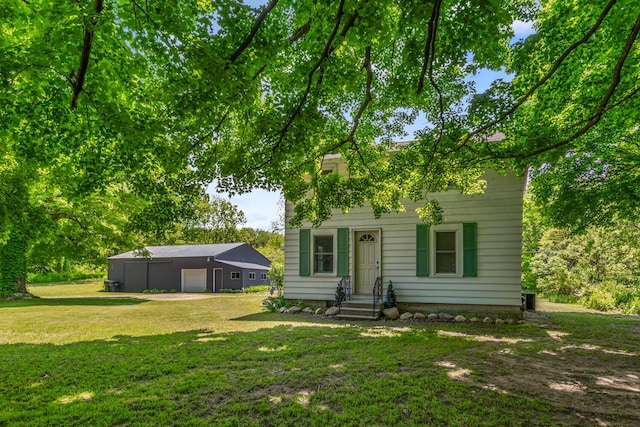 9303 W H Ave, Kalamazoo, MI 49009 - view of front of home featuring a front lawn, a garage, and an outdoor structure