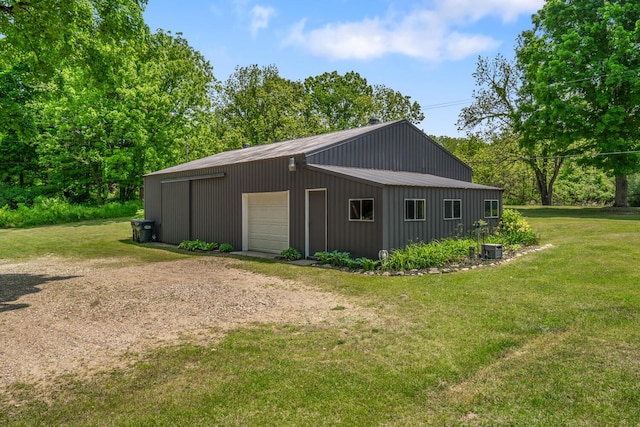 9303 W H Ave, Kalamazoo, MI 49009 - view of property exterior featuring a detached garage, an outbuilding, a yard, and driveway