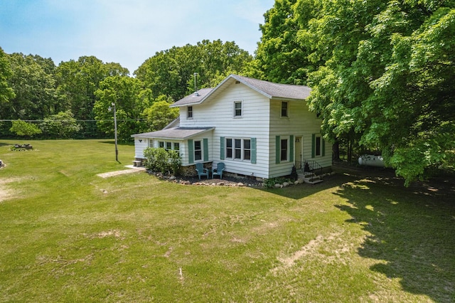 9303 W H Ave, Kalamazoo, MI 49009 - rear view of property featuring entry steps, a lawn, and roof with shingles