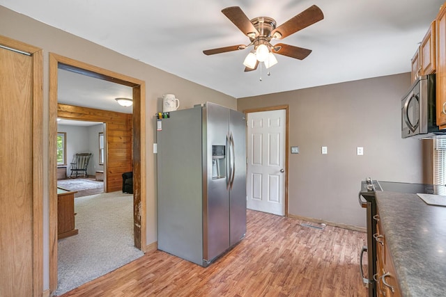 9303 W H Ave, Kalamazoo, MI 49009 - kitchen featuring appliances with stainless steel finishes, light wood finished floors, dark countertops, and ceiling fan