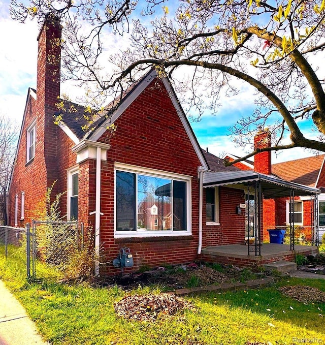 18459 Hubbell St, Detroit, MI 48235 - view of property exterior featuring a chimney, brick siding, and a porch