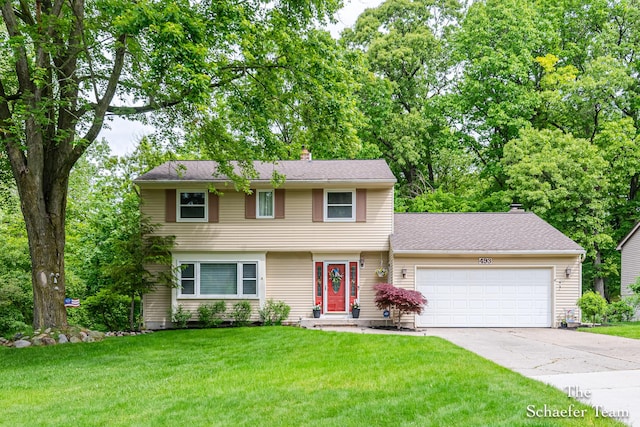 493 Edgeworthe Dr SE, Ada, MI 49301 - colonial inspired home featuring a chimney, a garage, driveway, and a front lawn