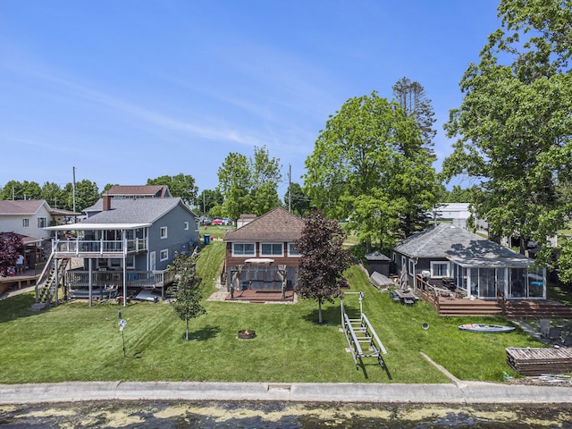 263 Waffle Dr, Coldwater, MI 49036 - rear view of property with a sunroom, a wooden deck, a yard, and a residential view