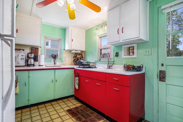 263 Waffle Dr, Coldwater, MI 49036 - kitchen with ceiling fan, red cabinetry, light countertops, white cabinets, and white microwave