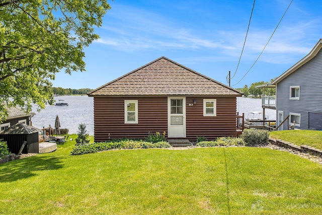 263 Waffle Dr, Coldwater, MI 49036 - back of house featuring a lawn, a water view, entry steps, and log veneer siding