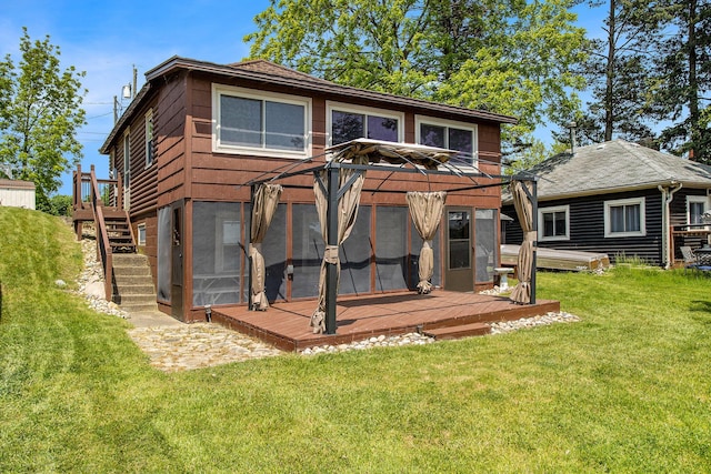 263 Waffle Dr, Coldwater, MI 49036 - rear view of house featuring a wooden deck, stairway, a lawn, and a sunroom