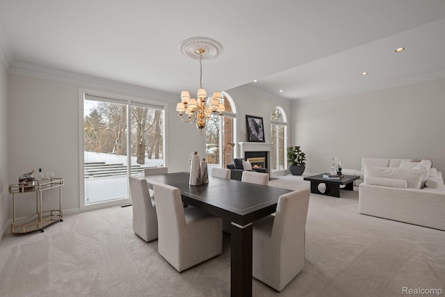 2729 Glenbrooke Ct, Bloomfield Hills, MI 48302 - dining area featuring light carpet, a chandelier, recessed lighting, crown molding, and a lit fireplace