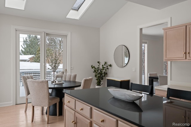 2729 Glenbrooke Ct, Bloomfield Hills, MI 48302 - dining area featuring a skylight, light wood-style flooring, and lofted ceiling