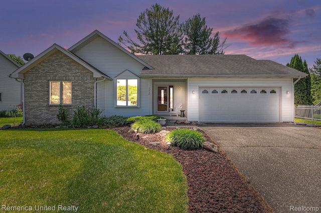 2458 Oseola Ave, Howell, MI 48843 - single story home with asphalt driveway, a garage, a lawn, and brick siding