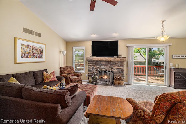2458 Oseola Ave, Howell, MI 48843 - living area with carpet floors, healthy amount of natural light, ceiling fan, vaulted ceiling, and a fireplace