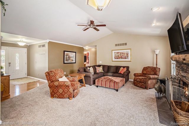2458 Oseola Ave, Howell, MI 48843 - carpeted living room featuring lofted ceiling, ceiling fan, crown molding, baseboards, and a fireplace