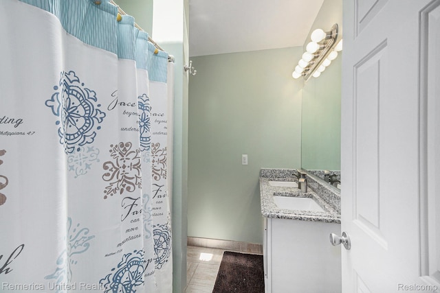 2458 Oseola Ave, Howell, MI 48843 - full bath with vanity, marble look tile flooring, baseboards, and curtained shower