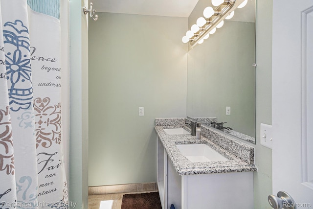 2458 Oseola Ave, Howell, MI 48843 - full bathroom with double vanity and baseboards