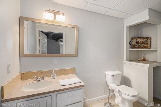 2458 Oseola Ave, Howell, MI 48843 - bathroom featuring toilet, a drop ceiling, vanity, and baseboards