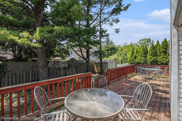 2458 Oseola Ave, Howell, MI 48843 - deck featuring outdoor dining space and a fenced backyard