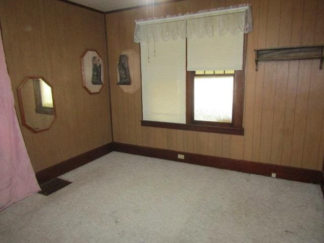 205 Pine St, Corunna, MI 48817 - carpeted spare room featuring wood walls