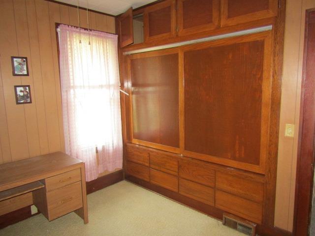 205 Pine St, Corunna, MI 48817 - mudroom featuring wooden walls and light carpet