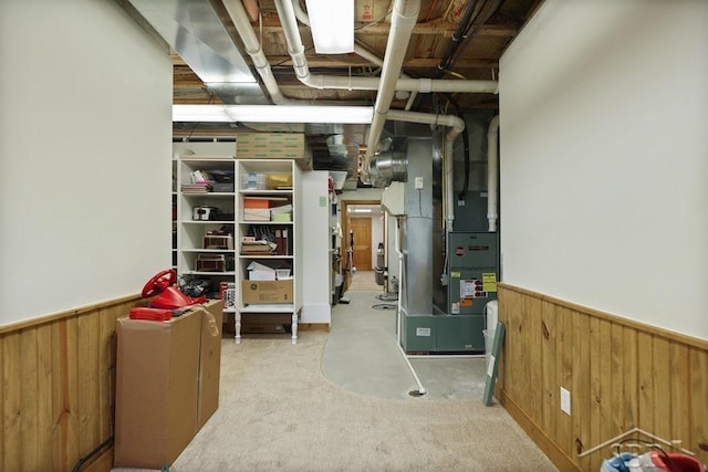 681 Quillett Dr, Beaverton, MI 48612 - finished basement featuring a wainscoted wall, wood walls, heating unit, and carpet floors