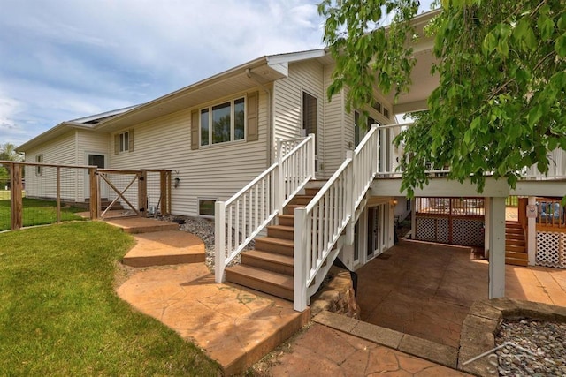 681 Quillett Dr, Beaverton, MI 48612 - rear view of property featuring stairs, a patio, and a lawn