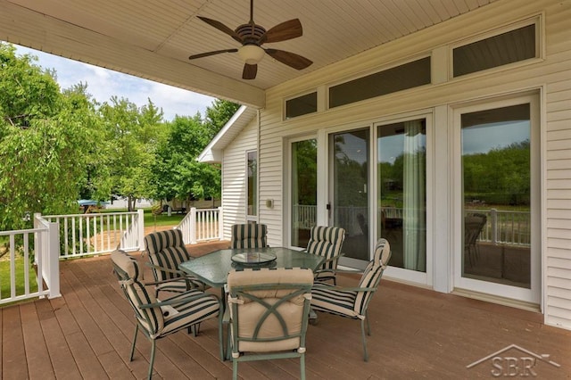 681 Quillett Dr, Beaverton, MI 48612 - deck with outdoor dining area and ceiling fan
