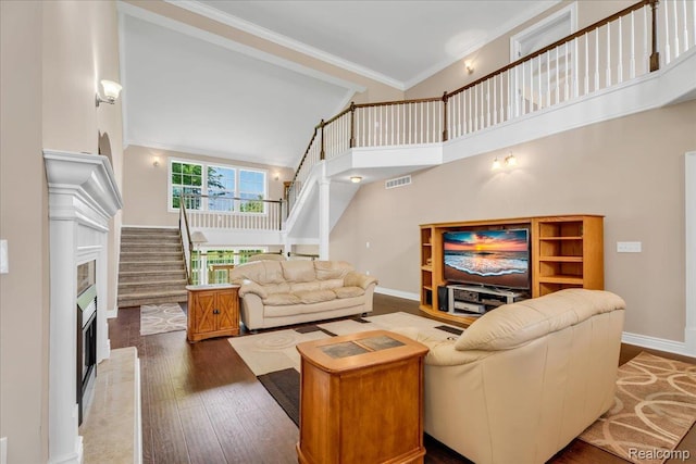 10726 Davisburg Rd, Davisburg, MI 48350 - living room with stairs, a towering ceiling, wood finished floors, ornamental molding, and baseboards