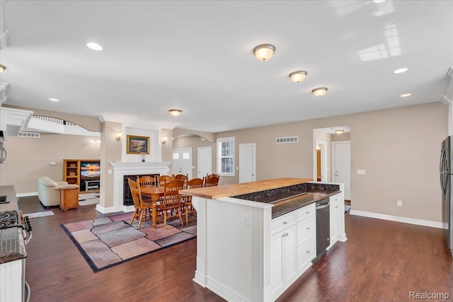 10726 Davisburg Rd, Davisburg, MI 48350 - kitchen with baseboards, white cabinets, dark wood-type flooring, freestanding refrigerator, and recessed lighting