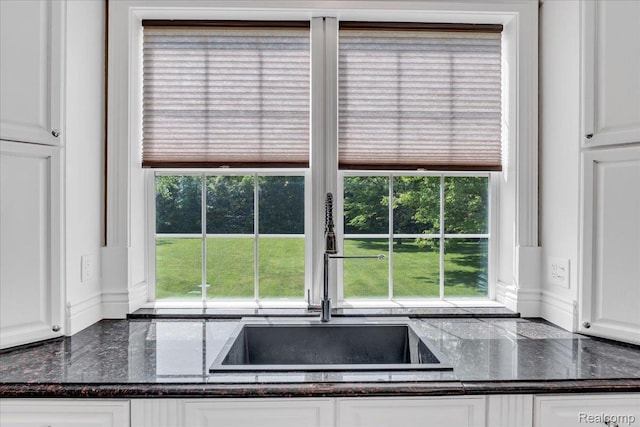 10726 Davisburg Rd, Davisburg, MI 48350 - kitchen featuring white cabinetry and dark stone countertops