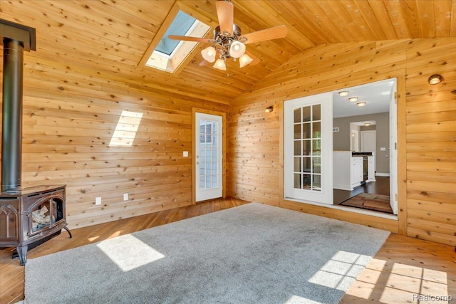 10726 Davisburg Rd, Davisburg, MI 48350 - spare room with a wood stove, lofted ceiling, wood ceiling, ceiling fan, and hardwood / wood-style floors