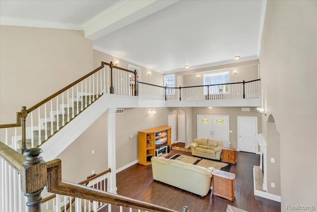 10726 Davisburg Rd, Davisburg, MI 48350 - living area with wood finished floors, arched walkways, crown molding, a high ceiling, and stairway