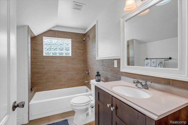 10726 Davisburg Rd, Davisburg, MI 48350 - full bathroom with vanity, shower / bath combination, toilet, vaulted ceiling, and tile walls