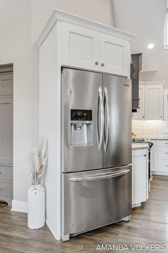 1551 Providence Cove Ct, Byron Center, MI 49315 - kitchen featuring stainless steel fridge with ice dispenser, gas range, light wood-style floors, white cabinetry, and recessed lighting