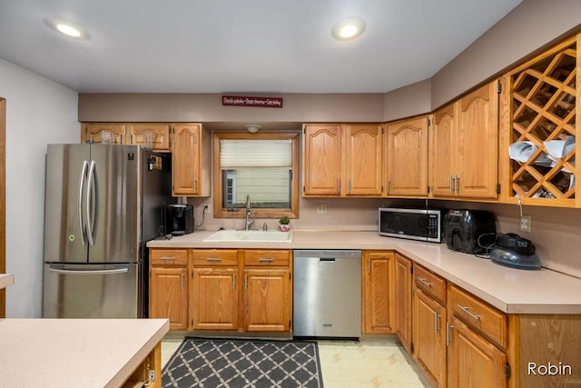 1032 White Ave NW, Grand Rapids, MI 49504 - kitchen with stainless steel appliances, a sink, light countertops, recessed lighting, and brown cabinets