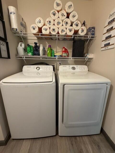 17912 130th Ave, Nunica, MI 49448 - washroom featuring wood finished floors, washing machine and dryer, and baseboards