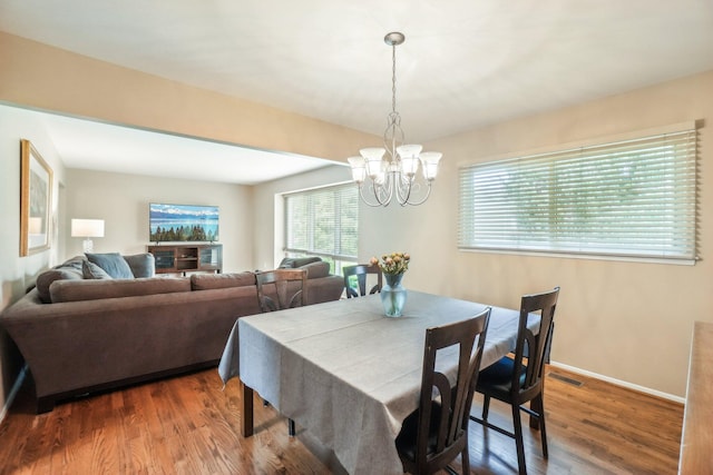 6883 Tamerlane Dr, West Bloomfield, MI 48322 - dining area with a chandelier, wood finished floors, and baseboards