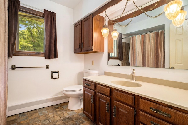 3765 Ryerson Rd, Twin Lake, MI 49457 - full bath with vanity, toilet, baseboards, stone finish floors, and a shower with curtain