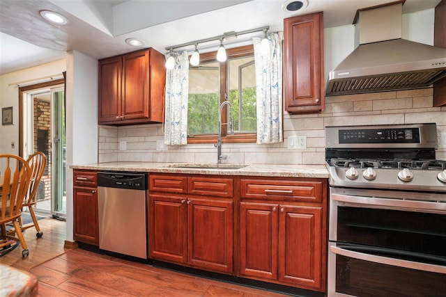 3765 Ryerson Rd, Twin Lake, MI 49457 - kitchen featuring appliances with stainless steel finishes, wall chimney exhaust hood, a sink, backsplash, and recessed lighting