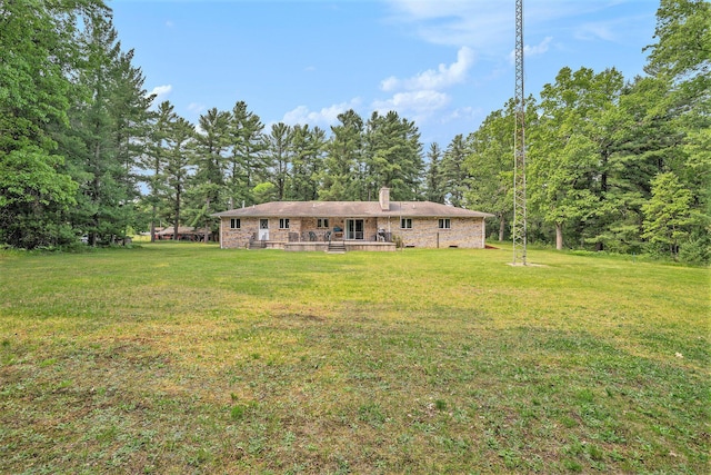 3765 Ryerson Rd, Twin Lake, MI 49457 - back of property featuring a chimney, a lawn, a wooden deck, and brick siding